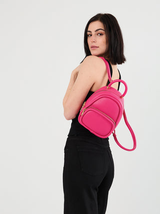 Valencia Vegan Backpack fuchsia on model, top handle and crossbody strap