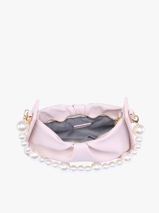 Light pink Ibiza vegan pearl shoulder bag open view showing interior lining and bow.
