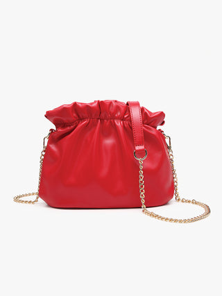 Red cinched crossbody bag with drawstring top and gold chain shoulder strap