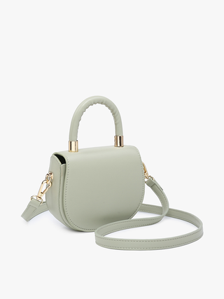 Vegan mini saddle bag in light sage with gold-tone top handle and crossbody strap.
