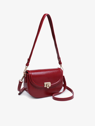 Cherry red crossbody bag with rounded flap, chain hardware, and adjustable shoulder strap