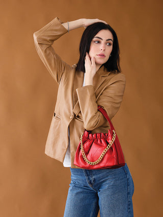 Ruched vegan bucket bag in red with gold chain strap and gathered ruched top