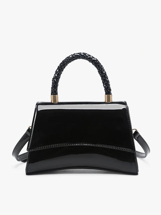 Black curvilinear crossbody bag with braided handle, glossy finish, front flap