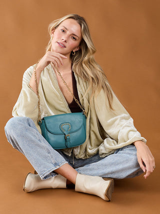 Ocean Blue vegan crossbody bag with studded heart front and chain shoulder strap