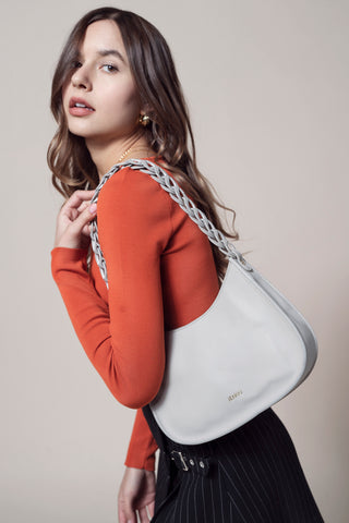 Vegan curved shoulder bag worn on shoulder; light bag with chain strap