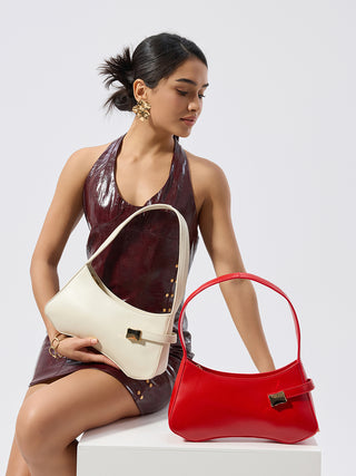 Two shoulder bags on model: cream and red, each with front clasp