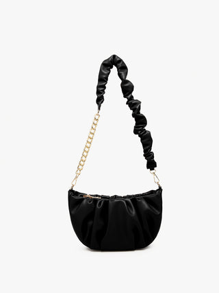 Black ruched shoulder bag with gold chain strap and ruched shoulder handle.