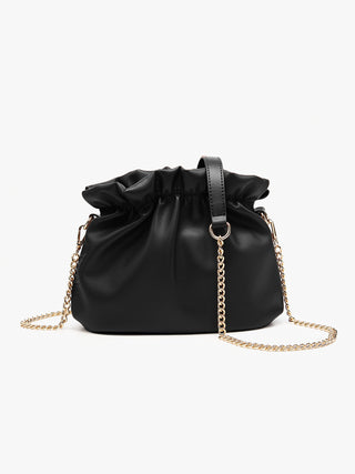 Black cinched crossbody bag with drawstring top, gold chain strap and leather tab