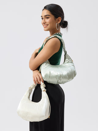 Pale Mint vegan puffy shoulder bag worn crossbody by model, ruched handle and gold details