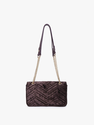 Dark velvet crossbody bag with chevron pattern, chain strap, and circular front ring