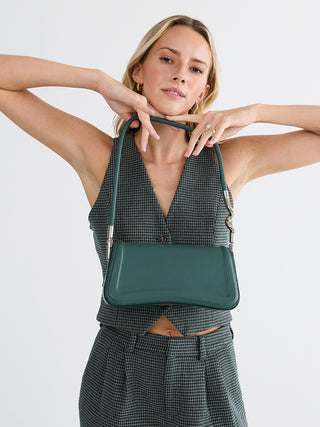 Toronto vegan curved shoulder bag, dark green top handle bag with chain straps on model