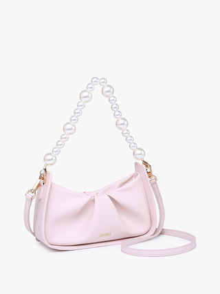 Light pink Ibiza vegan pearl shoulder bag with bow detail and crossbody strap extended.